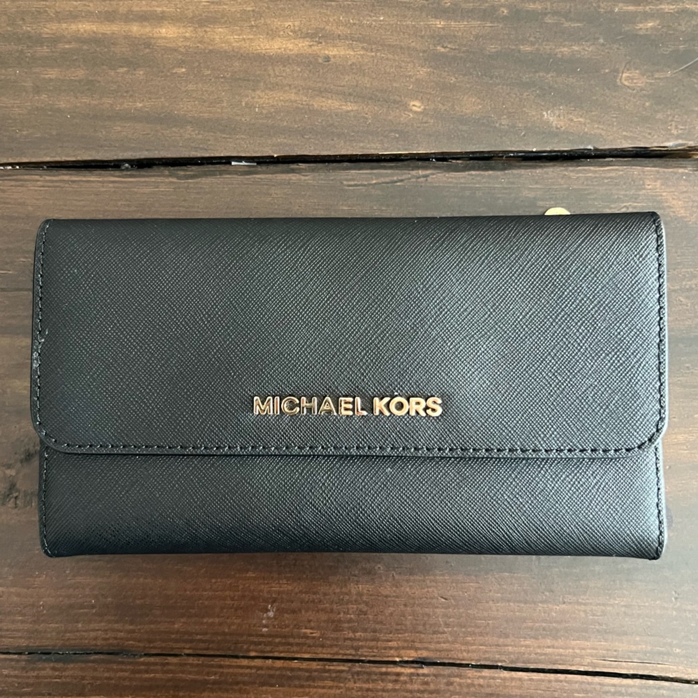 Black leather, Michael Kors wallet, snap close, 2 zipper pockets.
